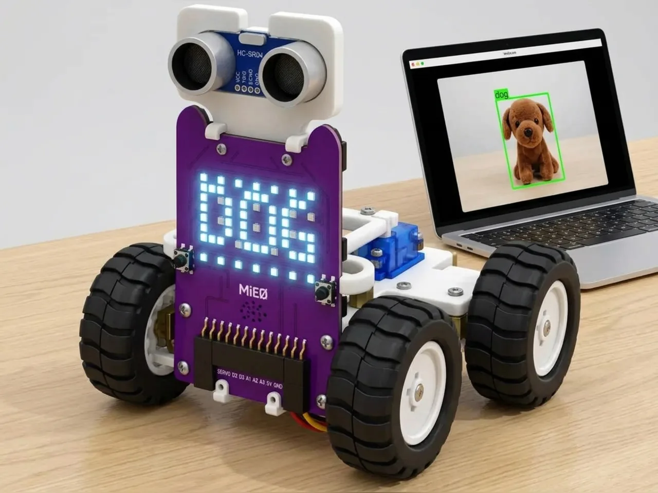MIEO scrolling the word DOG on its display while a laptop camera looks at a toy dog