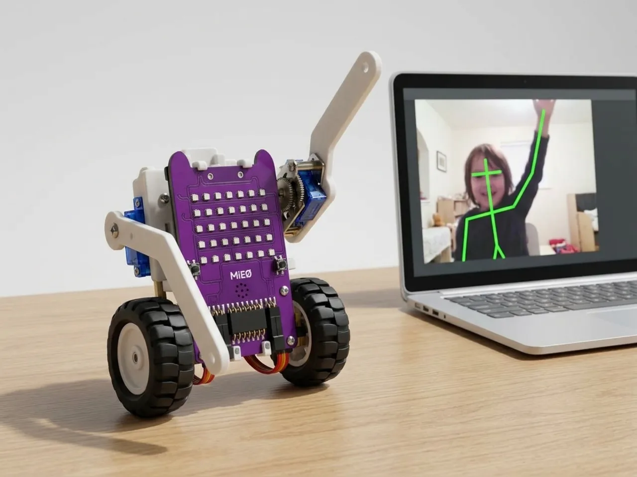MIEO raising its servo arm as a laptop camera tracks a child raising an arm