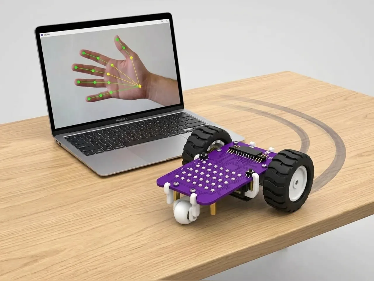 MIEO steering left as a laptop camera tracks a hand moving to the left