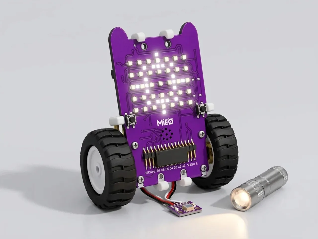 MIEO with a light sensor plugged in, its display glowing as a torch shines on it
