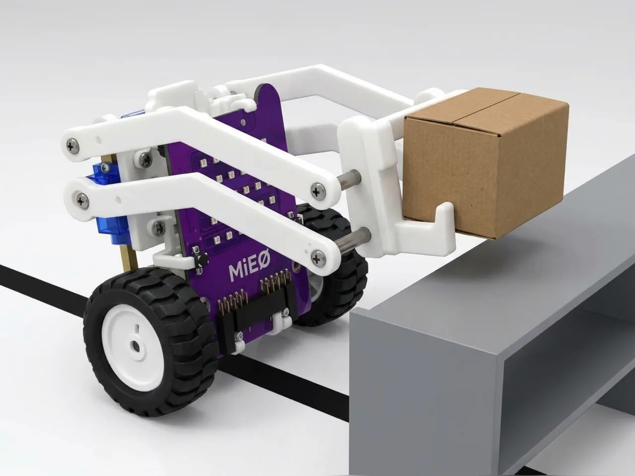 MIEO forklift lifting a small box beside a black line on the floor